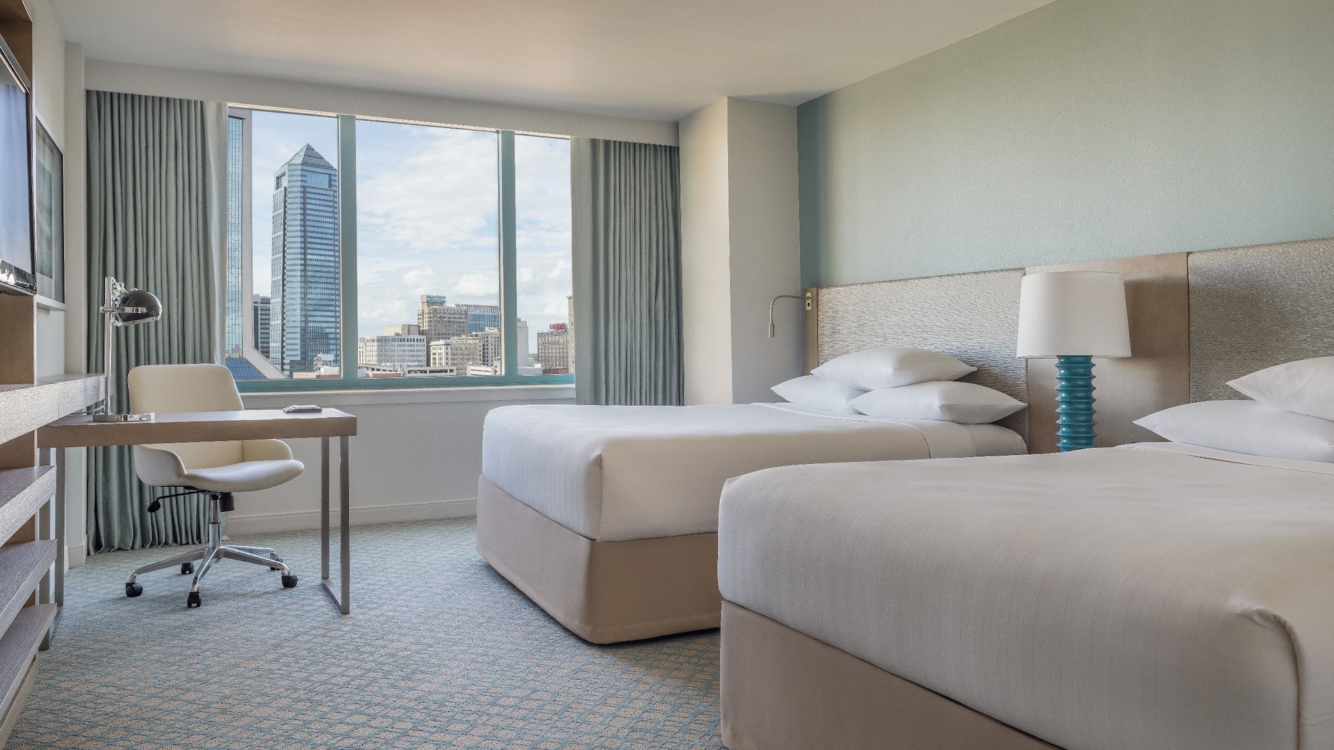 1 of 4 Two Queen Beds guest room with desk and city view