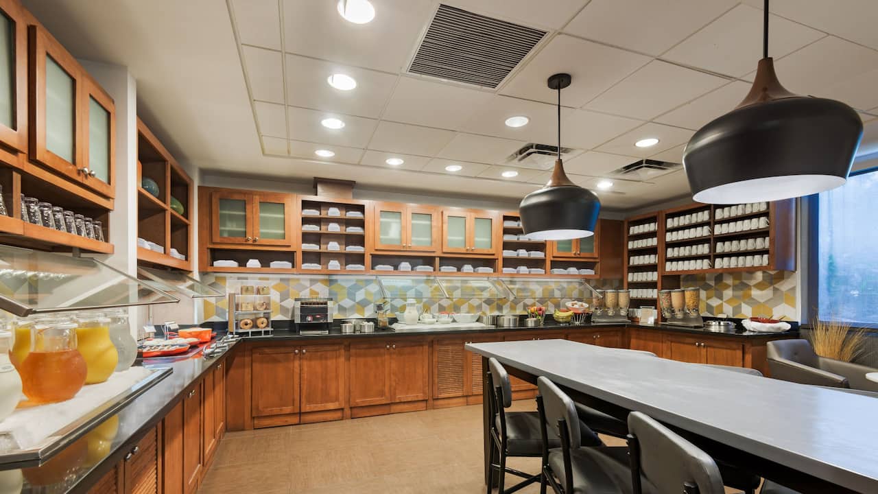 Breakfast Bar morning buffet with a variety of juice, cereal, pastries and hot and cold items