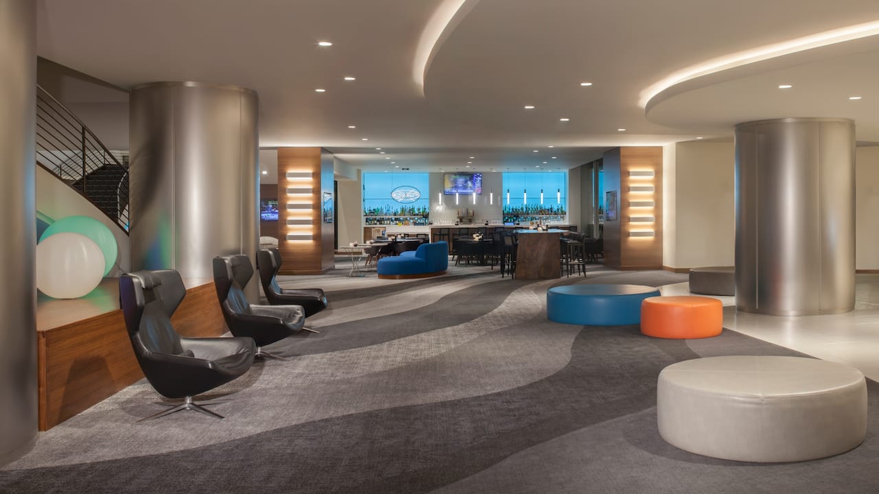 Lobby seating and bar area with outdoor views