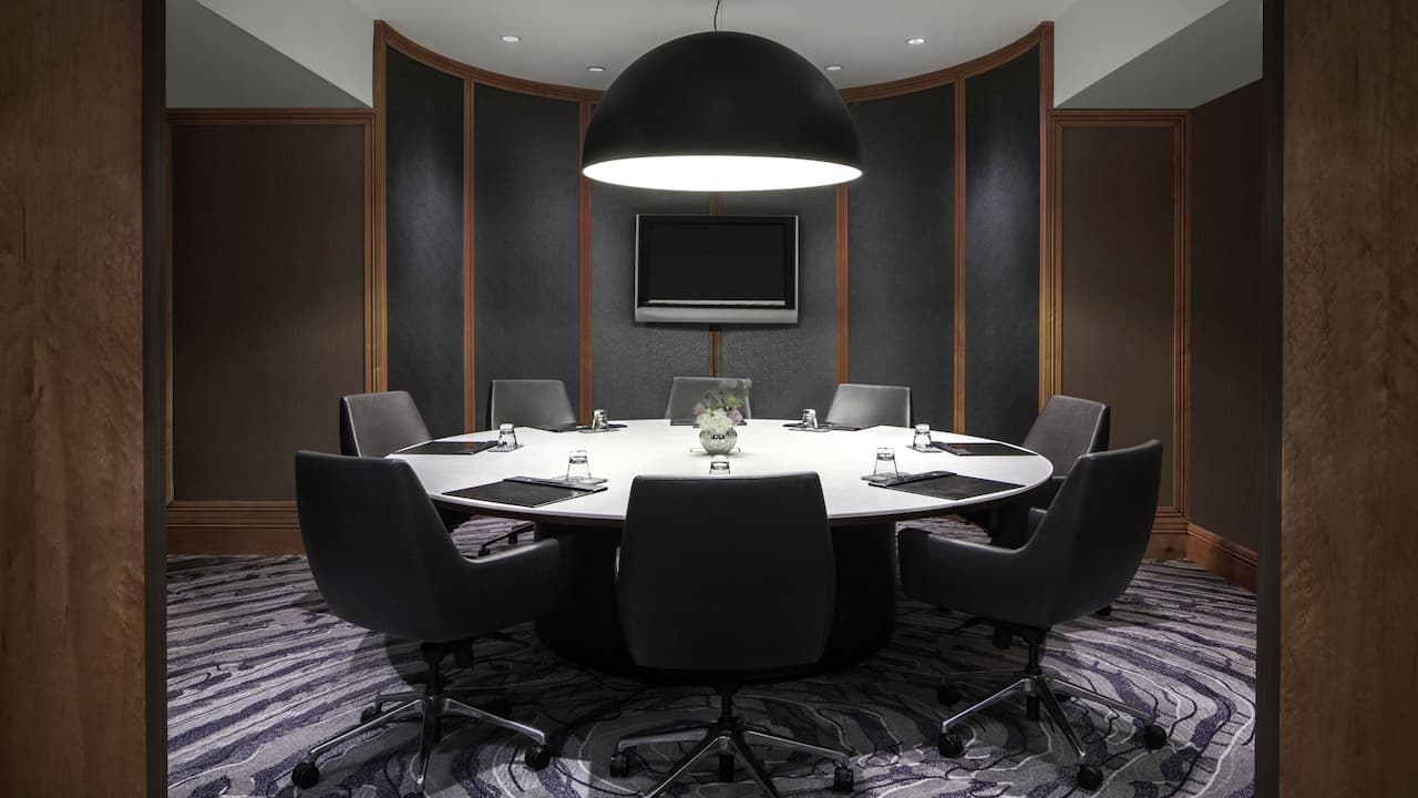 Large round table with executive chairs in meeting room