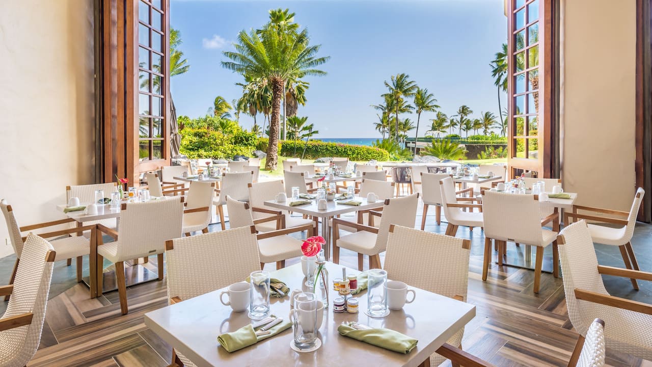 Ilima Terrace main dining areas with a garden view at Grand Hyatt Kauai Resort and Spa