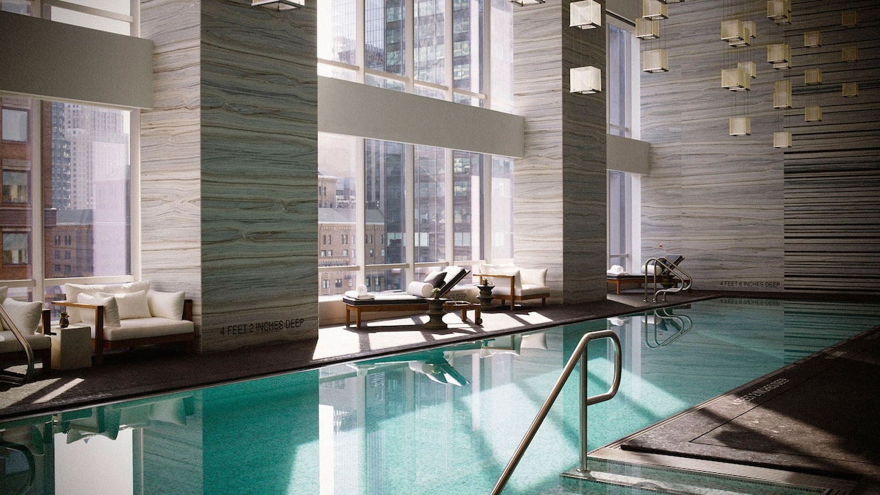 Indoor Pool with lounge seating and city view