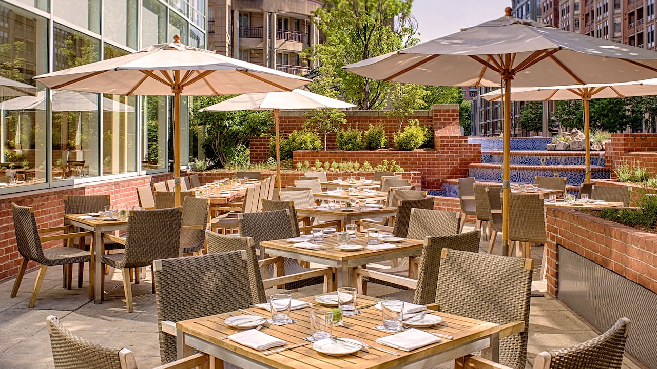 Outdoor dining area with tables and sun umbrellas 