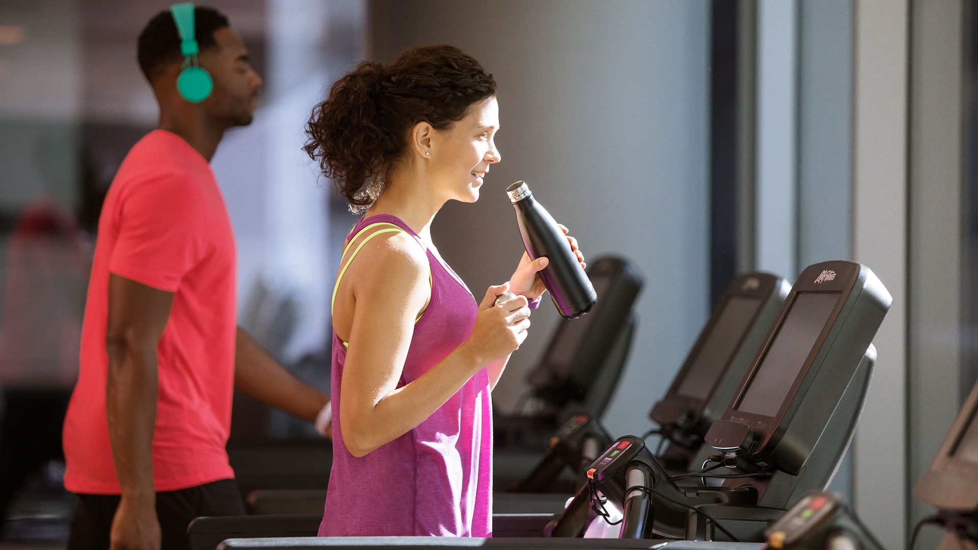 Woman and man on treadmill in the Fitness Club
