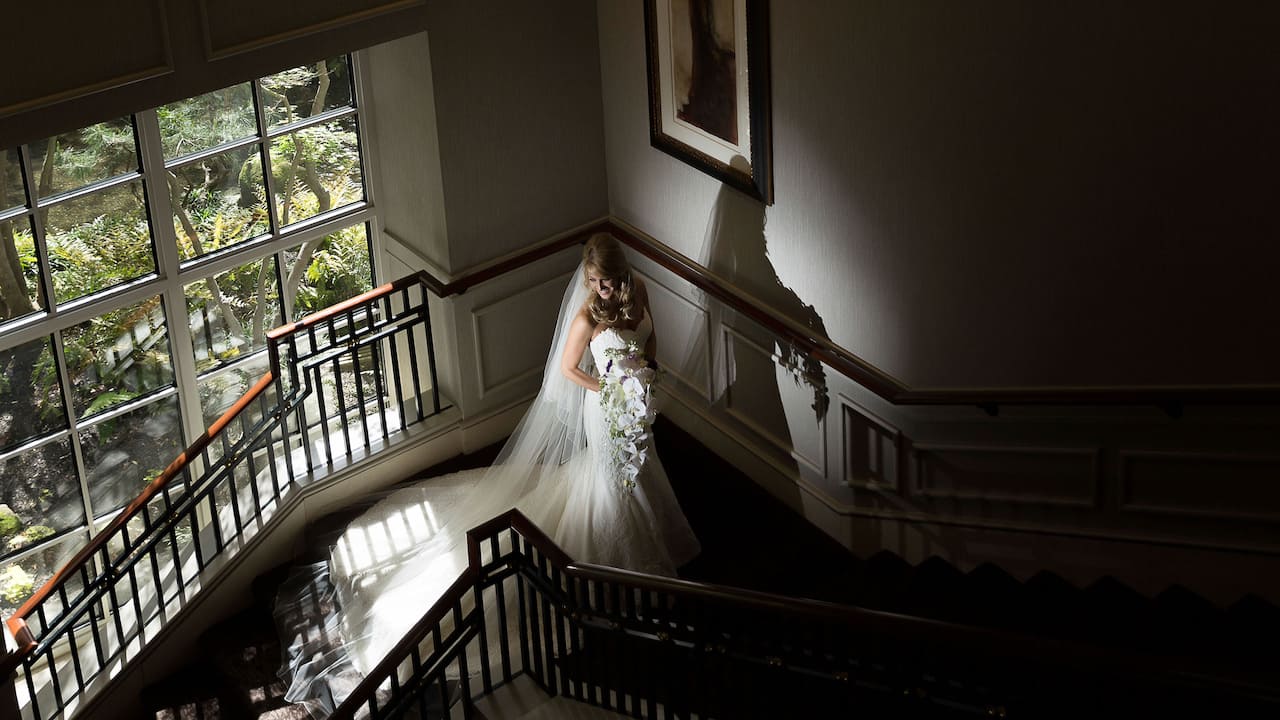 Bride posing on the hotel staircase