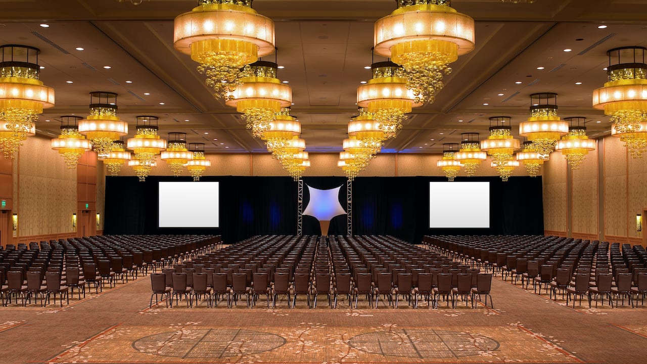 Large event space, Grand Ballroom, theater setup with stage and projector screens