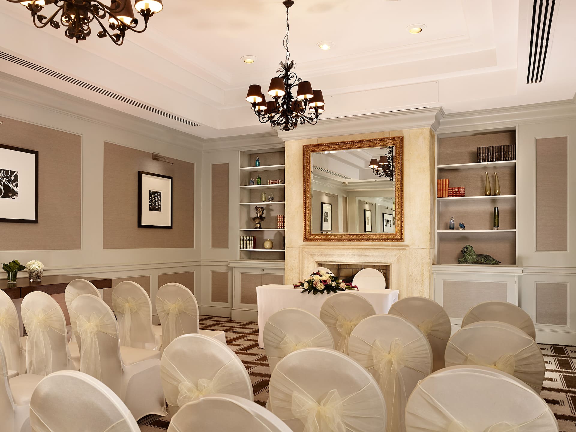 Modern beige and white event room in a theatre set up with decorated chairs for a luxury wedding in Hyatt Regency Birmingham.