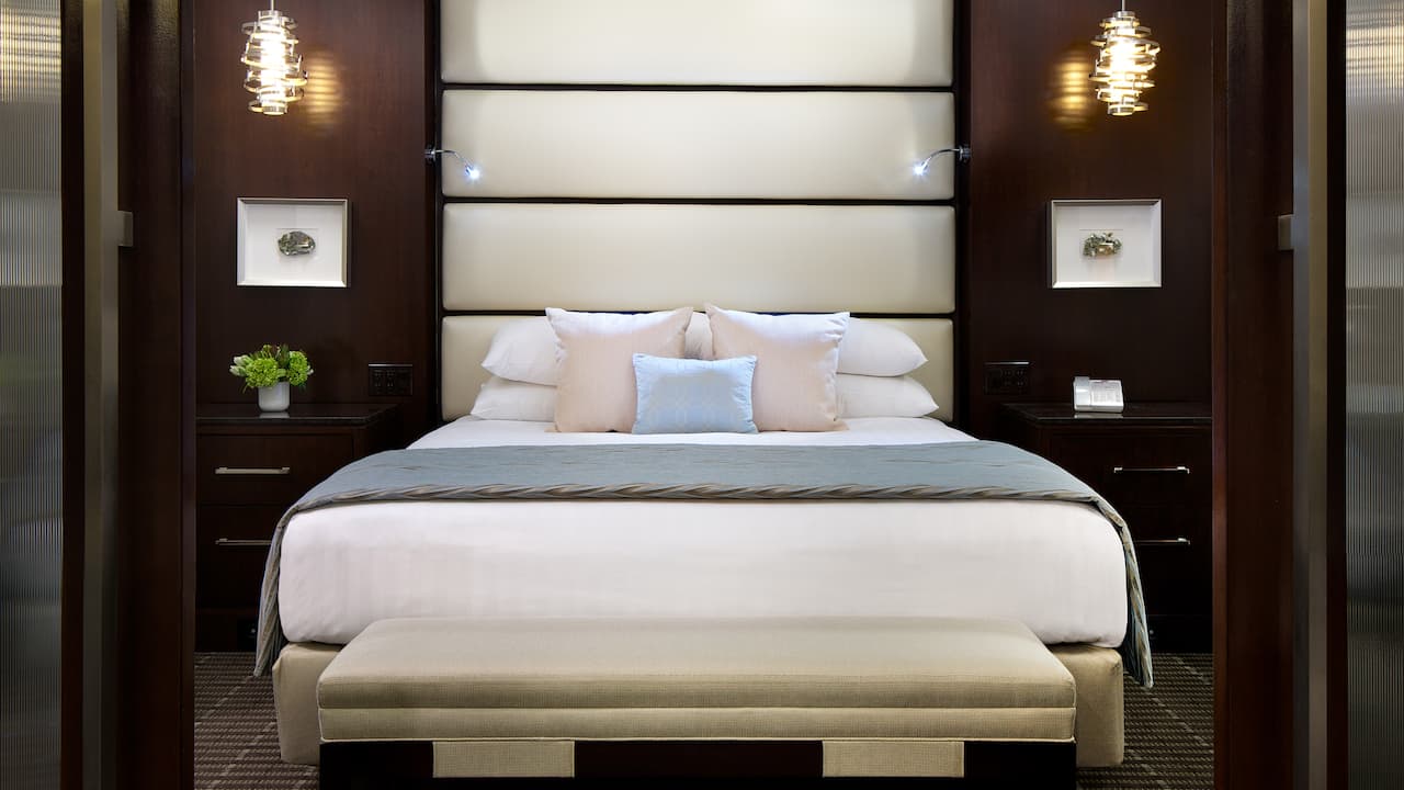 Comfy king-sized bed set in a beautifully designed suite bedroom 