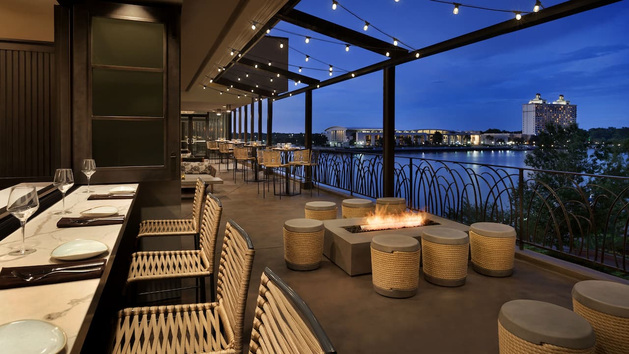 Moss + Oak Savannah Eatery terrace with river views at dusk