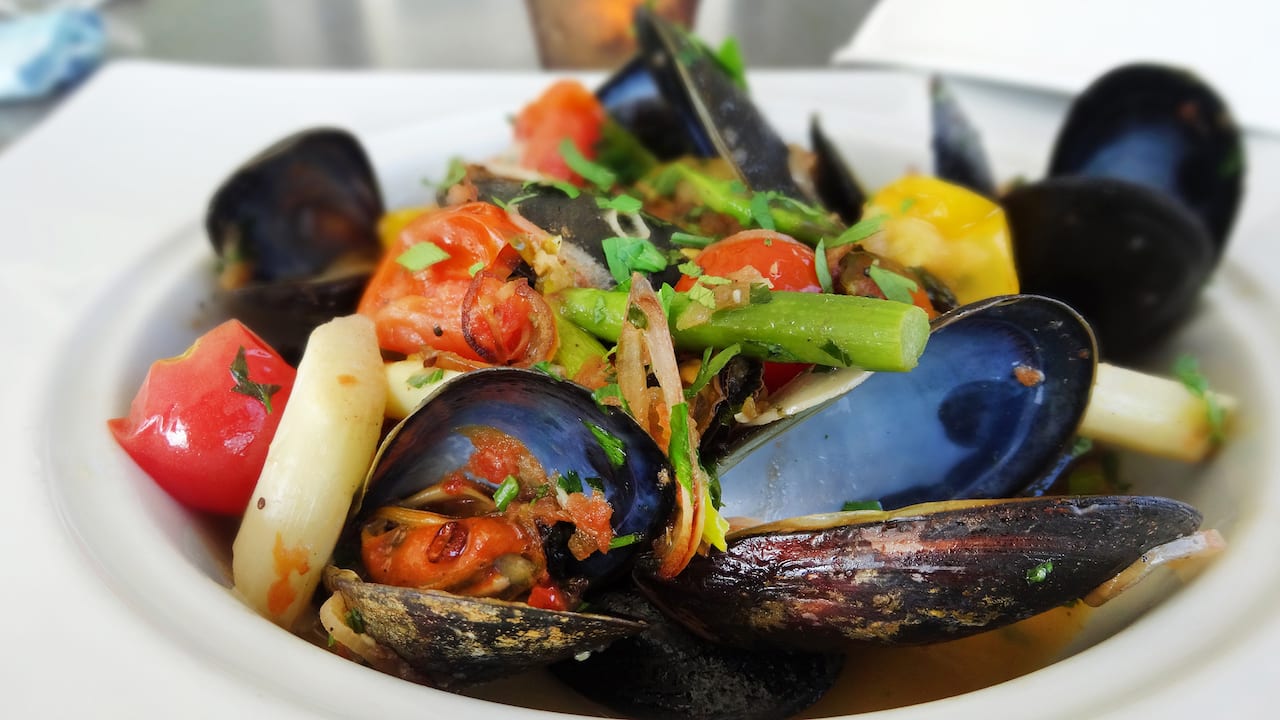 Serving bowl of mussels and assorted vegetables at a Bonita Springs Restaurant