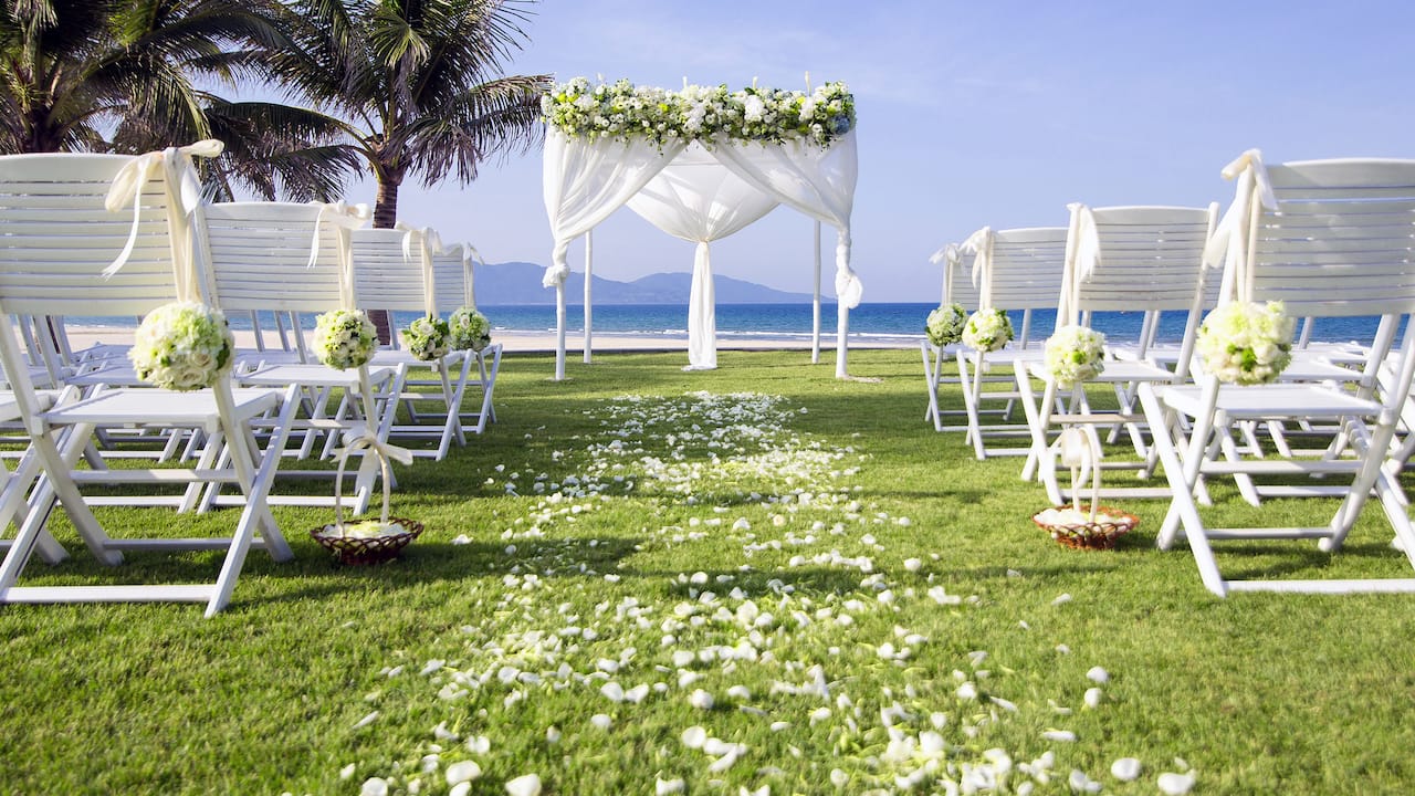 Beach Wedding Setup at Hyatt Regency Danang Hotel with Lush White Flowers