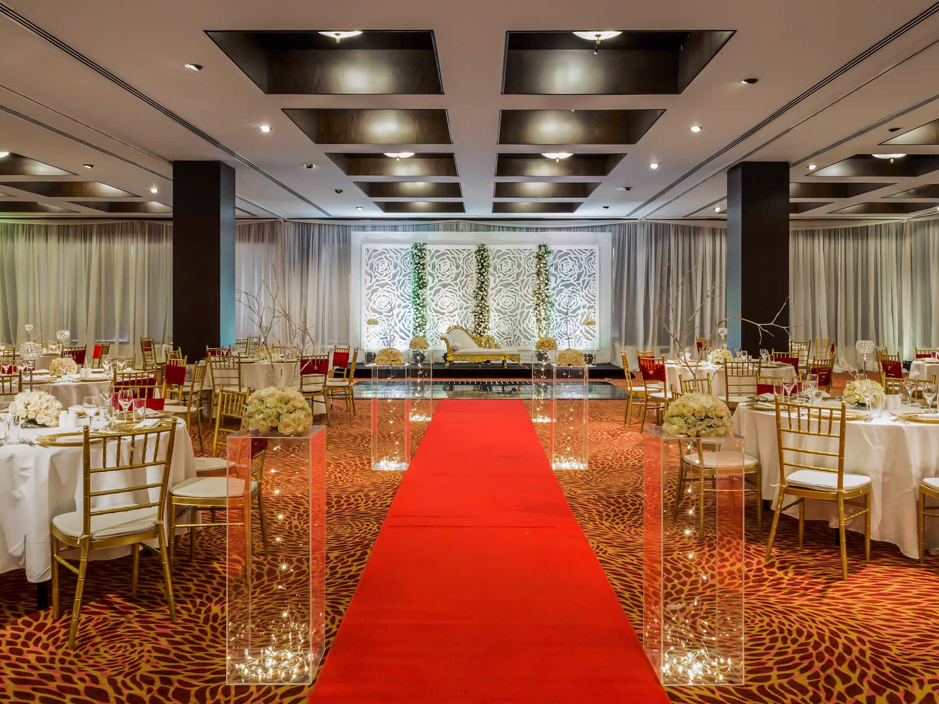 Hyatt Regency Dar es Salaam Ballroom wedding setup, featuring a red carpet and elegant floral decor.