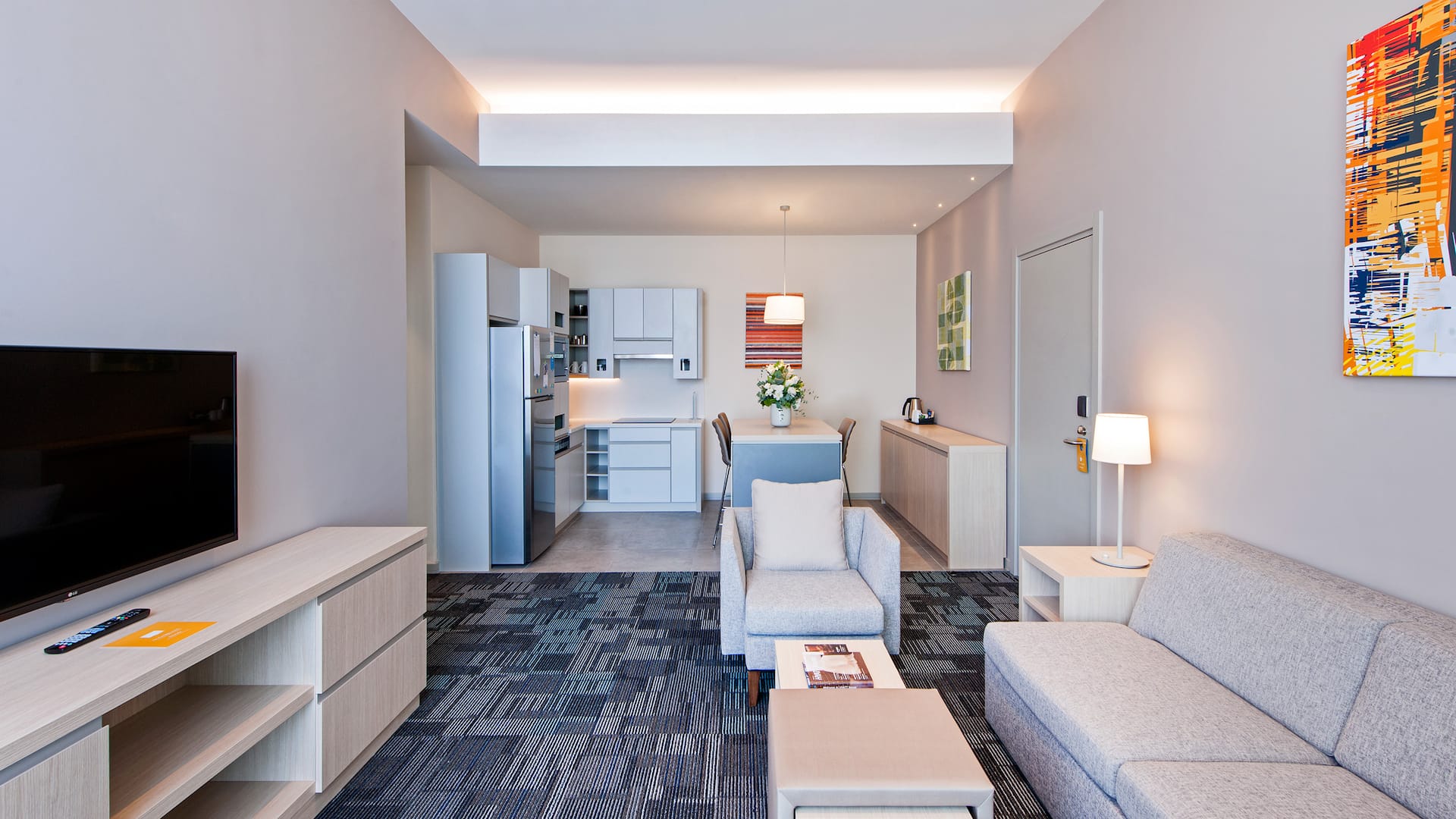 Hotel suite in Gebze with a kitchen, modern living area, coffee table, and TV unit at Hyatt House Gebze, offering a comfortable extended stay.