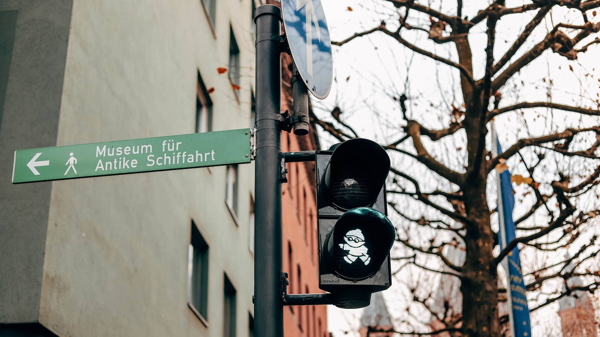 Traffic light with green Mainzelmaennchen symbol near the Rhine promenade close to Hyatt Regency Mainz