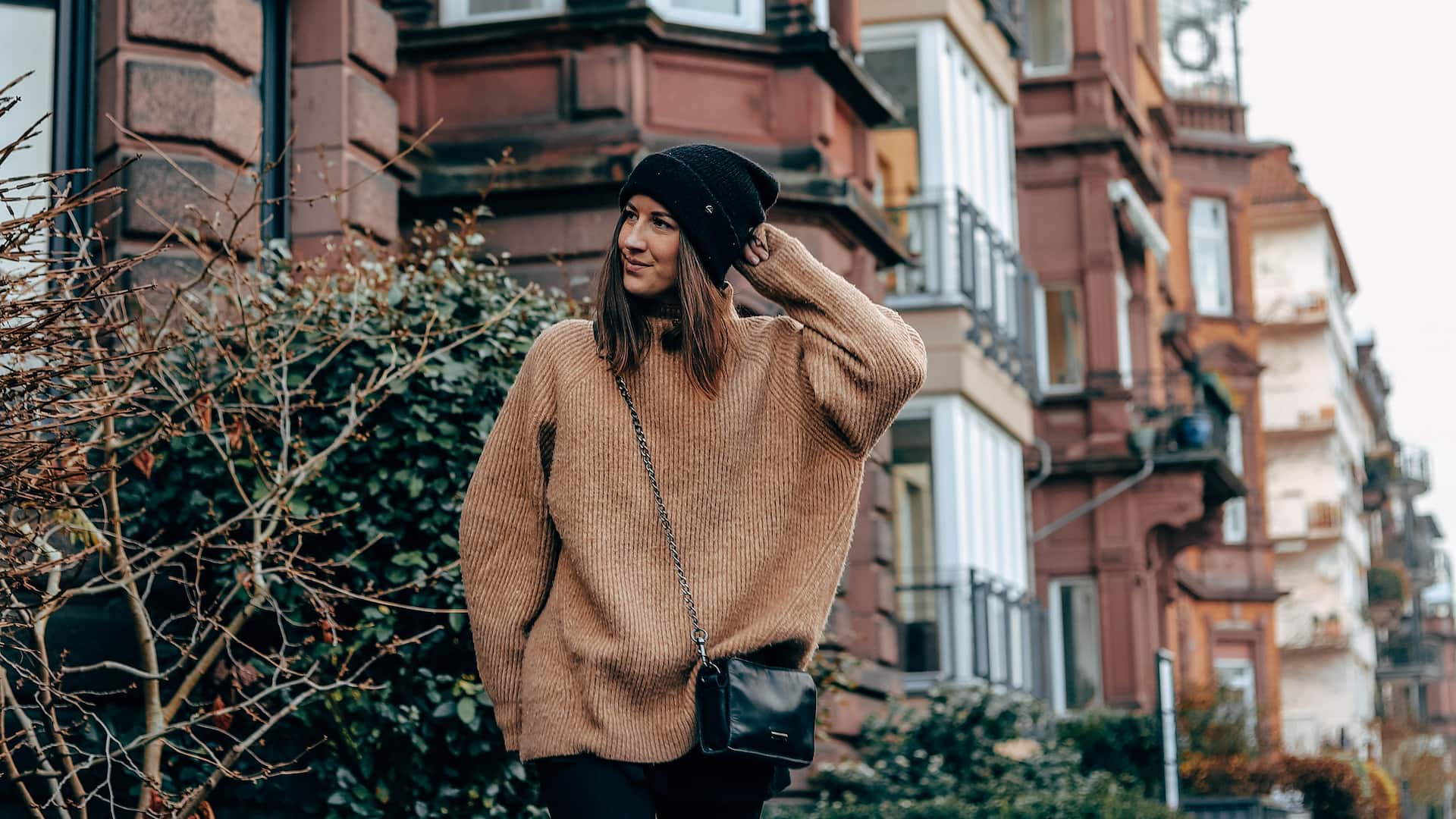 Woman walking through street with old houses in winter not far from Hyatt Regency Mainz