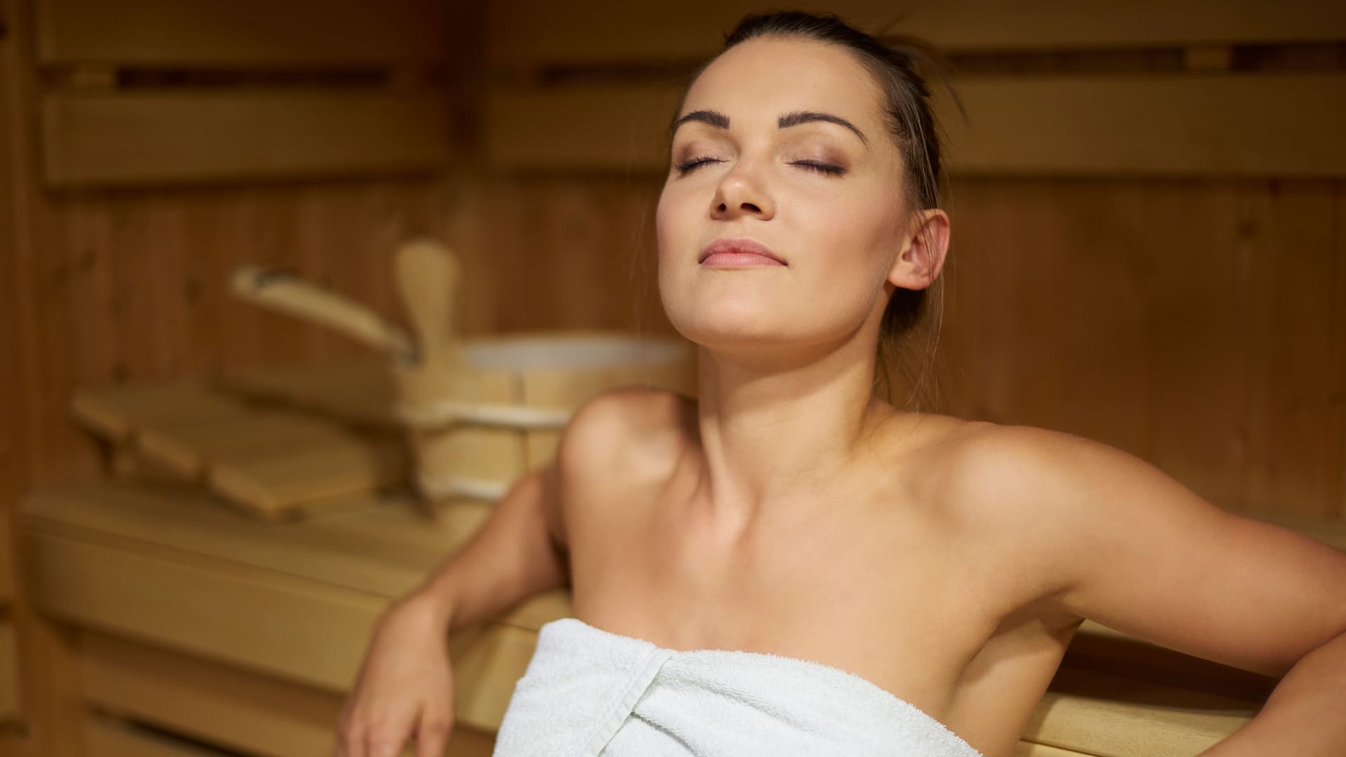 Woman enjoys sauna session at Fitness Club