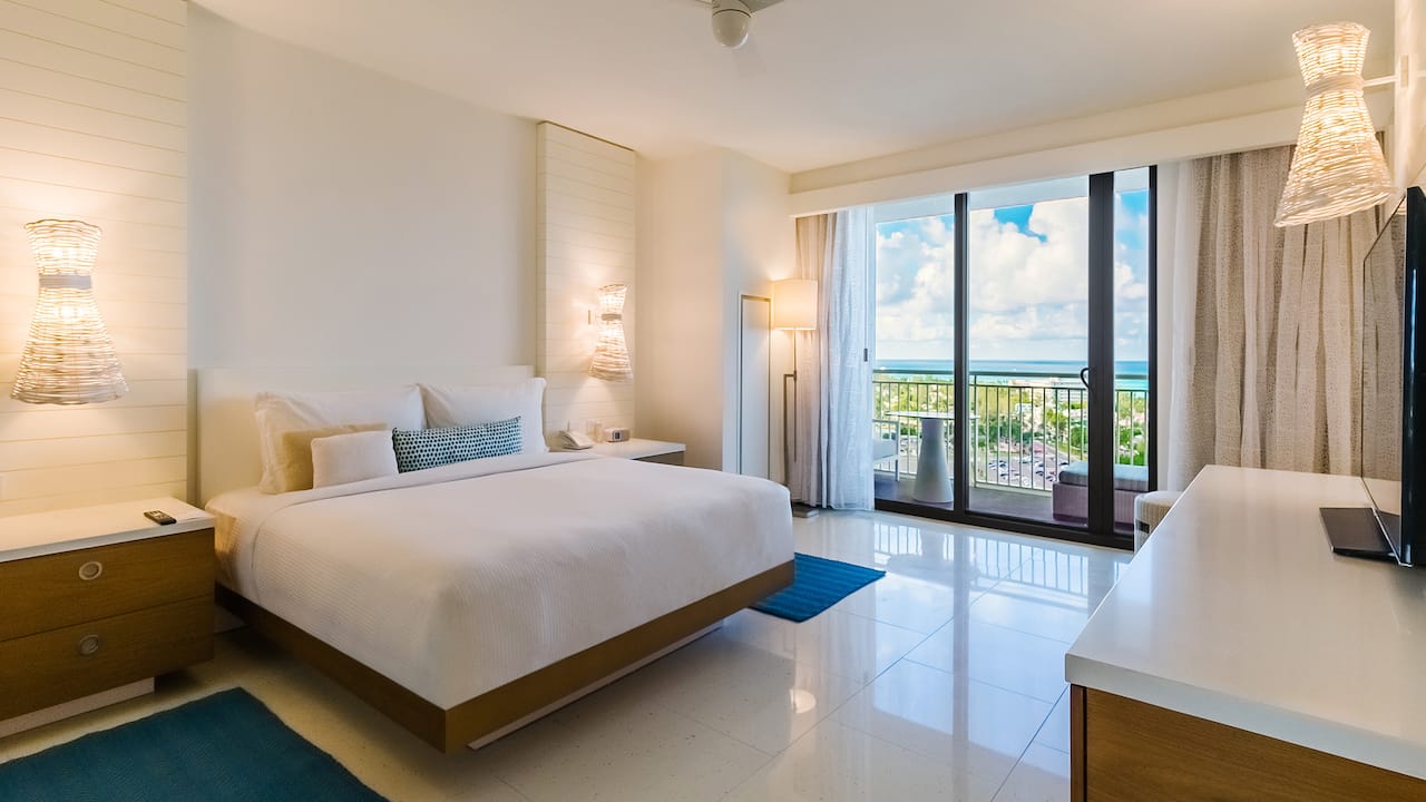 A king hotel resort bedroom with a beachfront balcony view in Nassau Bahamas