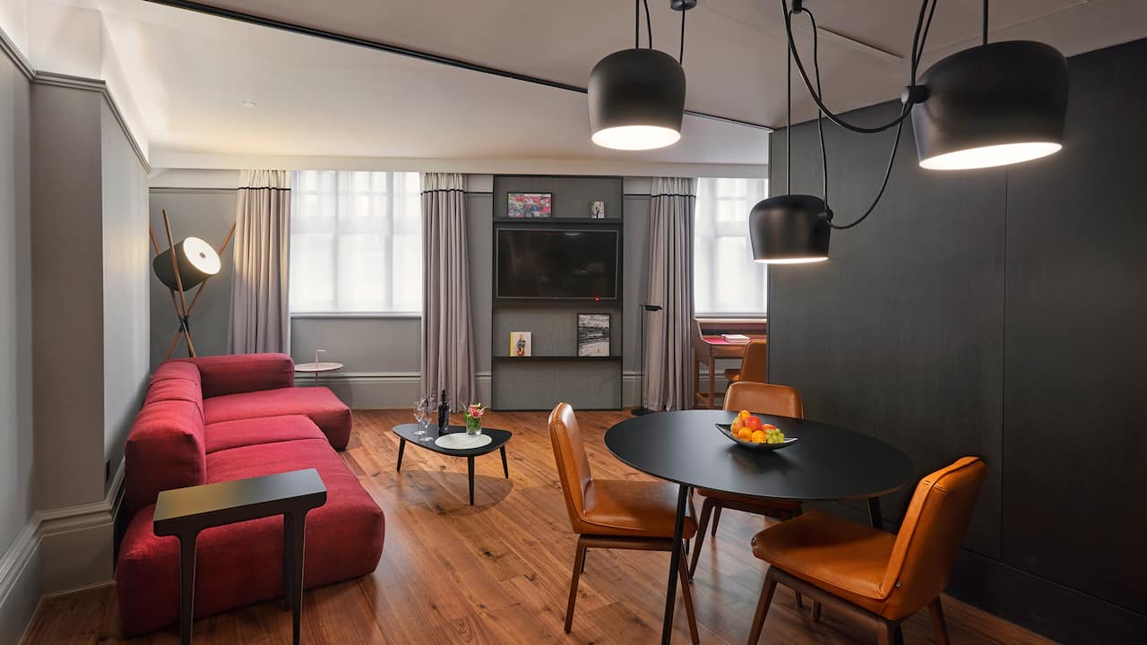 King room living space with sofa and table with chairs Andaz London Liverpool Street