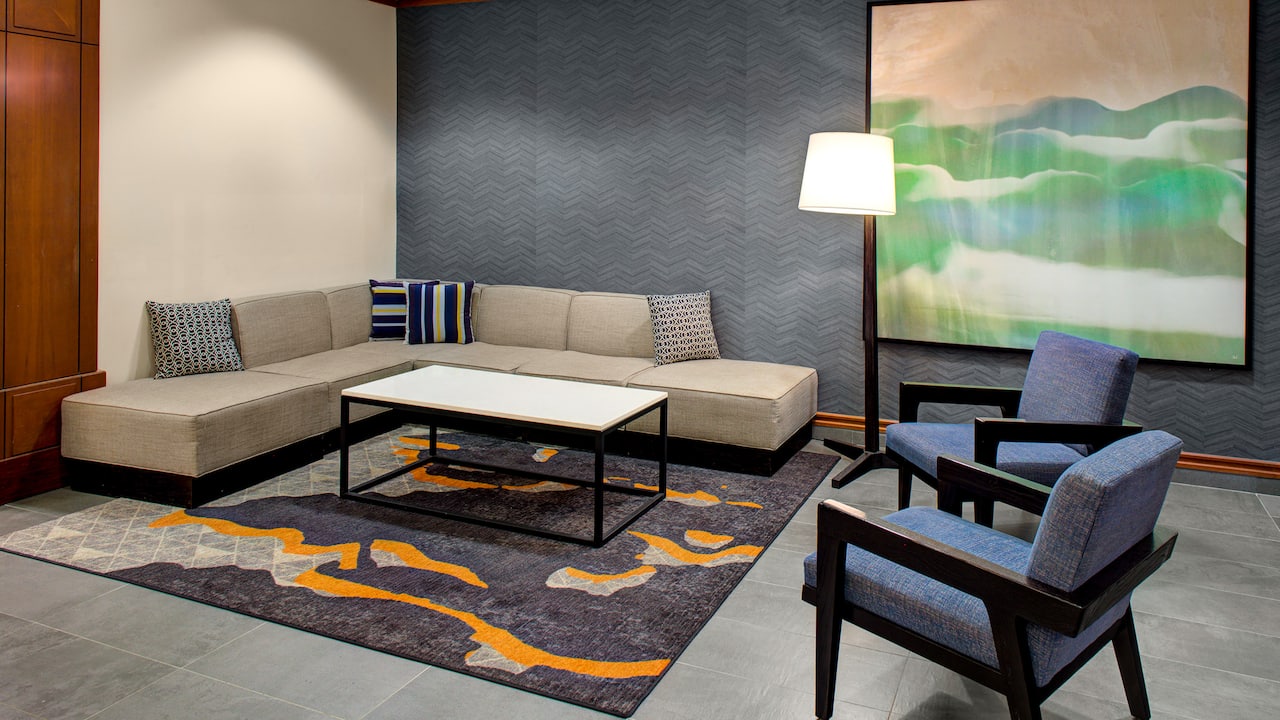 Lobby seating couch and two chairs with coffee table at Hyatt House Boston/ Burlington