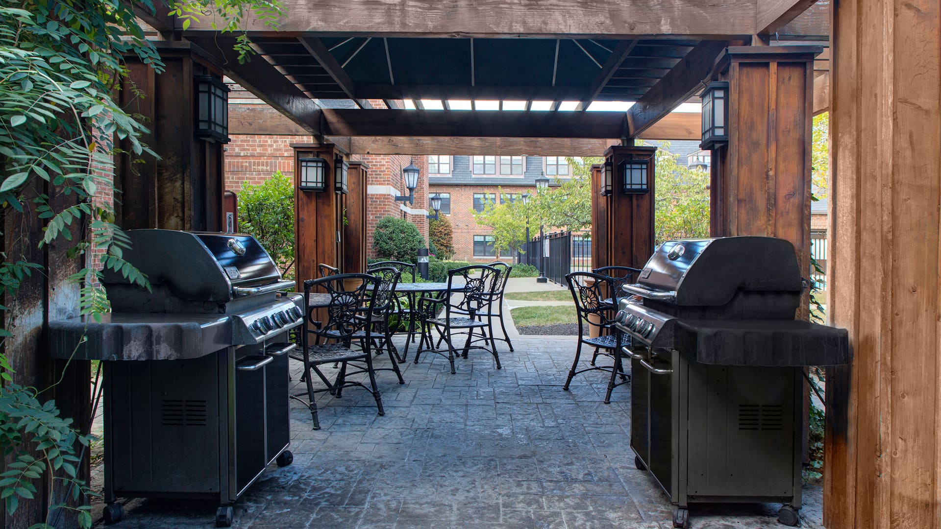 Patio area at Parsippany hotel with seating area and BBQ grills at Hyatt House Parsippany East