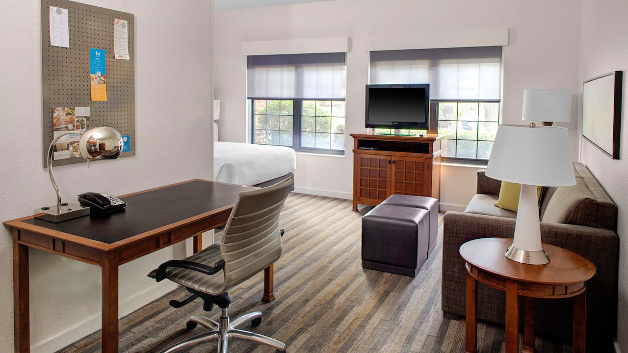 Queen studio room with desk, seating area, and tv at Hyatt House Parsippany East