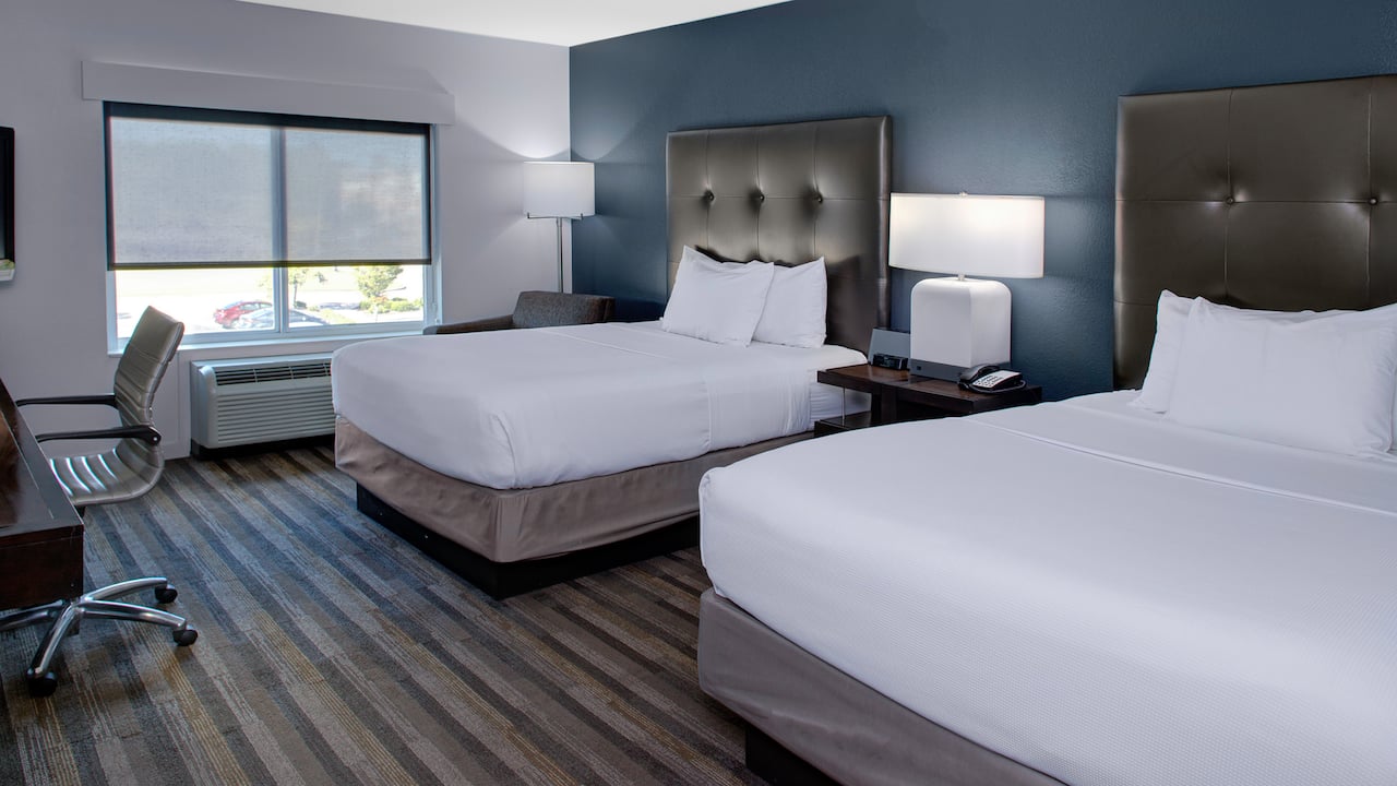 Double queen-size beds with nightstands at Hyatt House Raleigh Durham Airport.