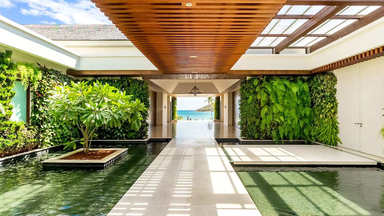 Welcome walkway with water feature, koi pond & living plant walls at Park Hyatt St. Kitts Christophe Harbour