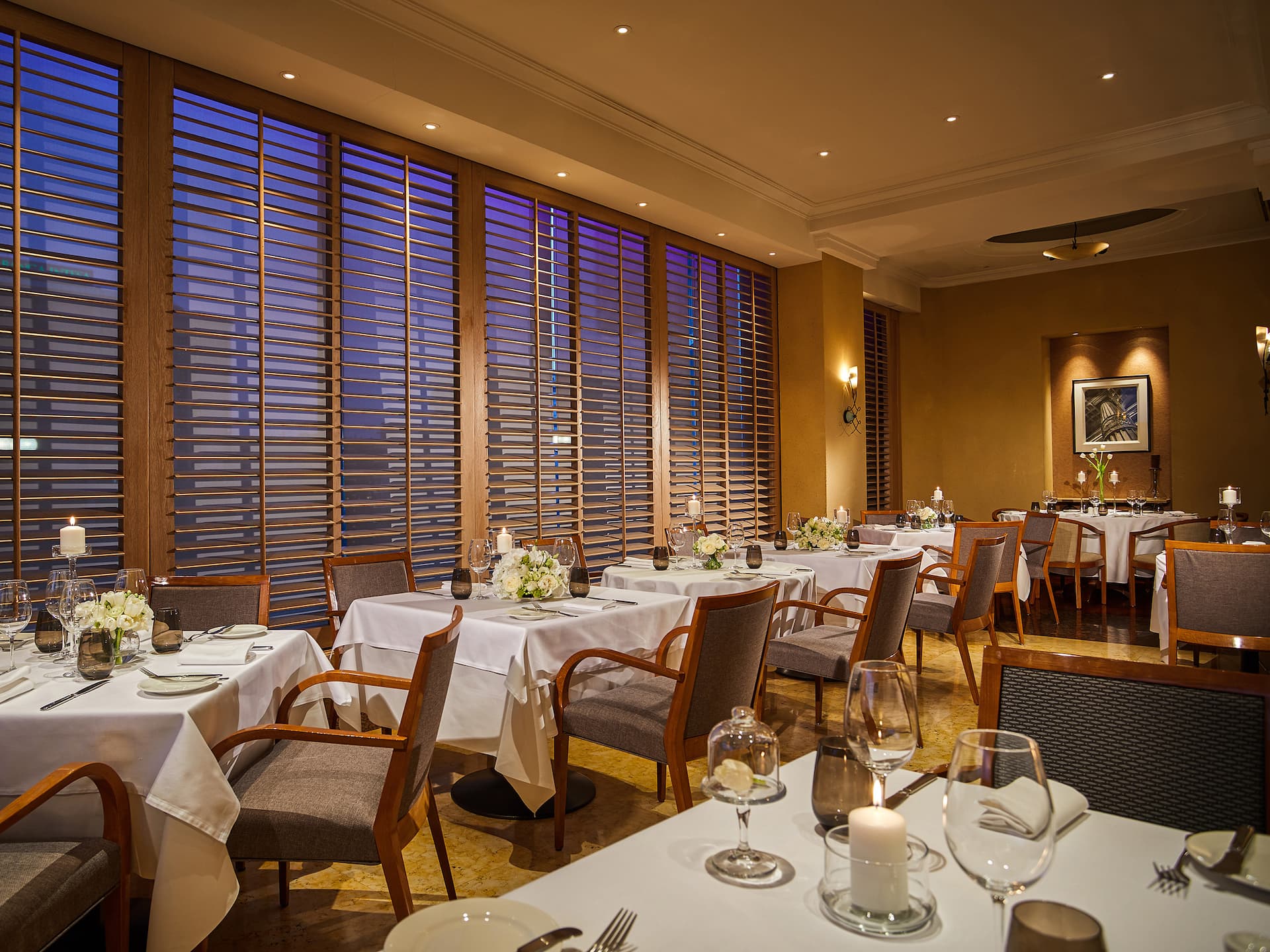 Elegant dinner setting at Metropolitan restaurant with stylish tables, ambient lighting, and a sophisticated atmosphere.