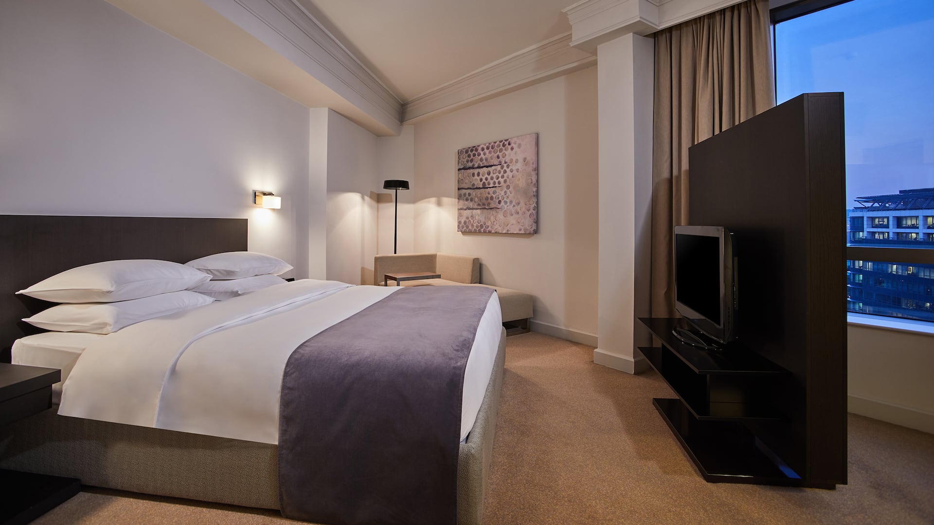 Spacious 96m² Regency Executive Suite with king bed, living/dining area, study room, and Regency Club access at Hyatt Regency Belgrade.
