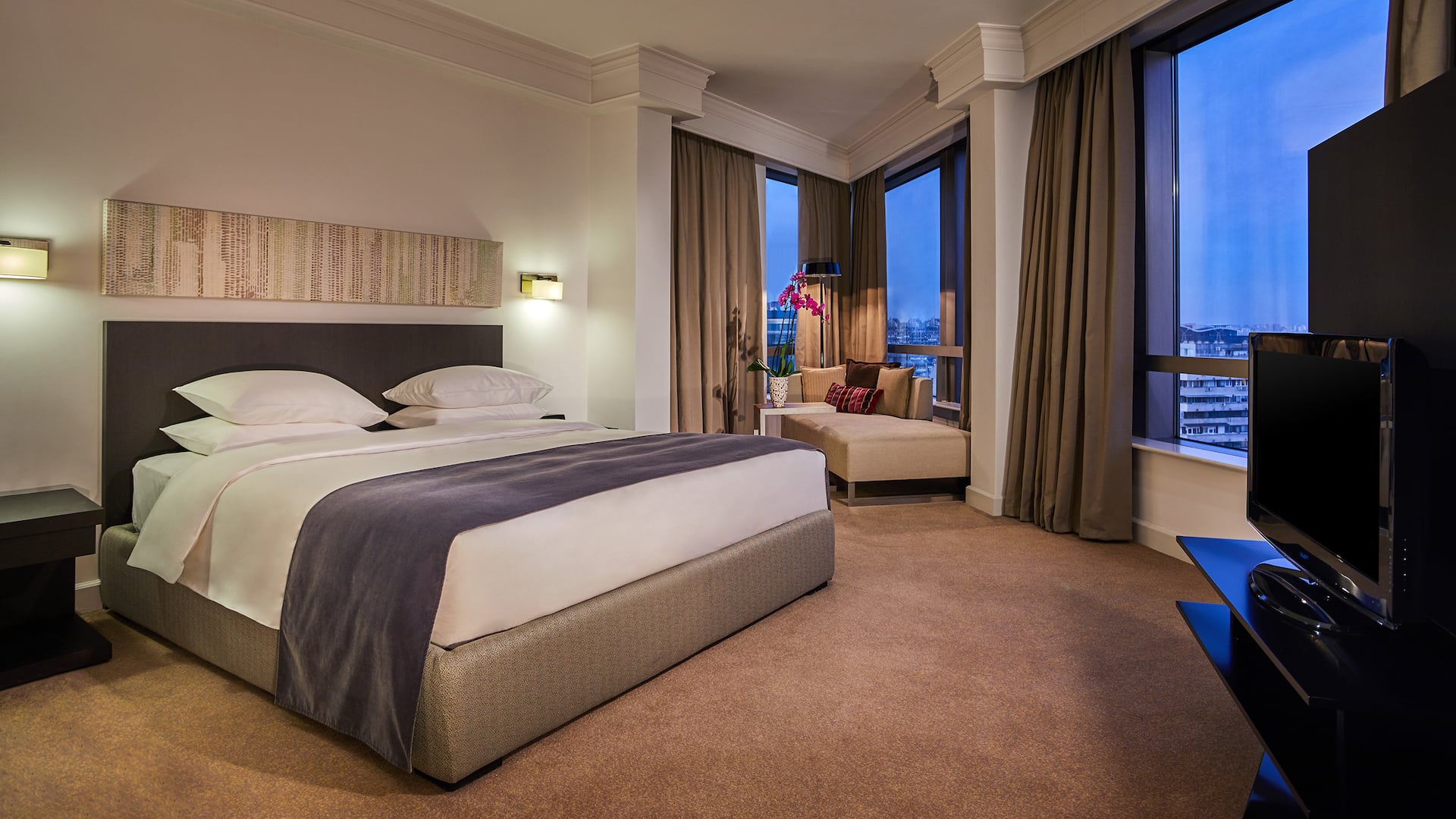 65m² Regency Suite with king bed, separate living room, work desk, and modern bathroom with bathtub and shower, plus Regency Club access.