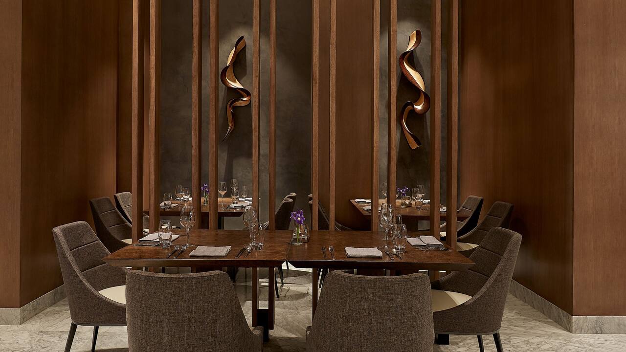 BLVD Bar lounge area with wood dining tables and chairs