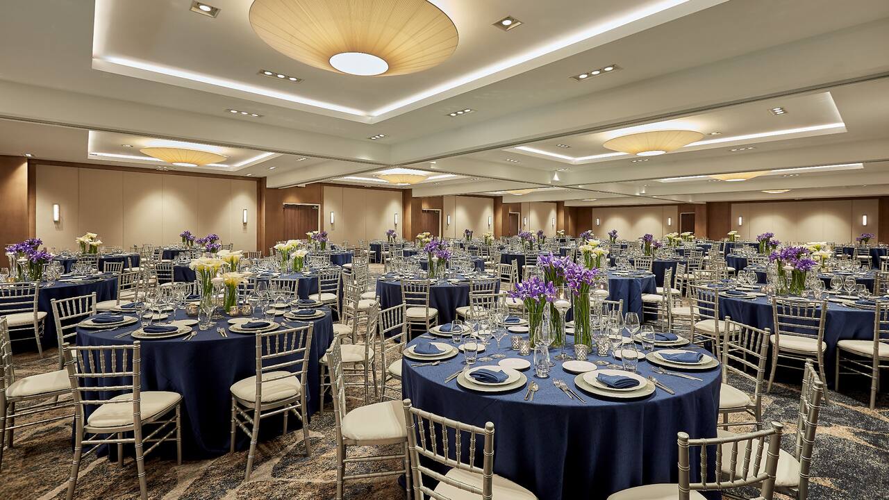 Pacific ballroom with round tables set up for a wedding reception