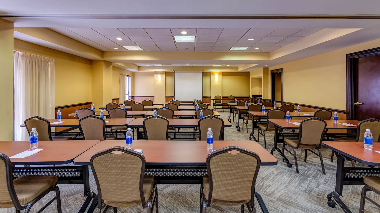 Rows of tables and chairs in hotel meeting room