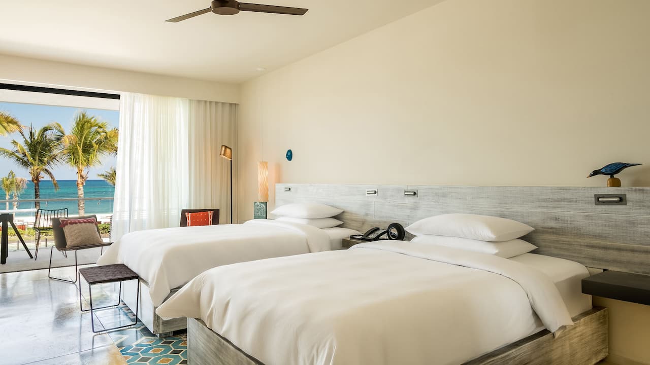 Two double bed resort room with a balcony overlooking the ocean at Andaz Mayakoba Resort Riviera Maya