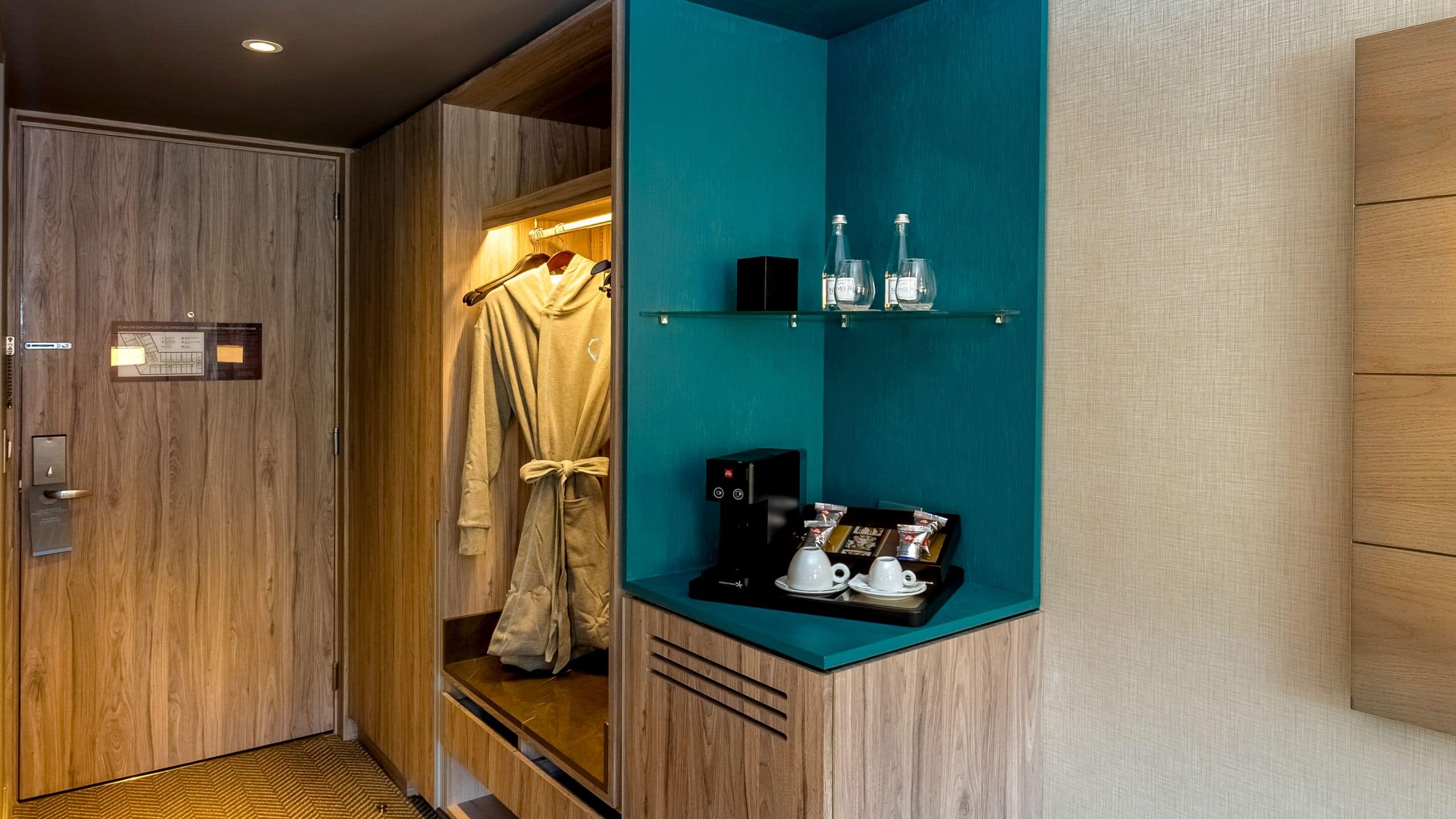 Guest room coffee station and closet with a plush robe