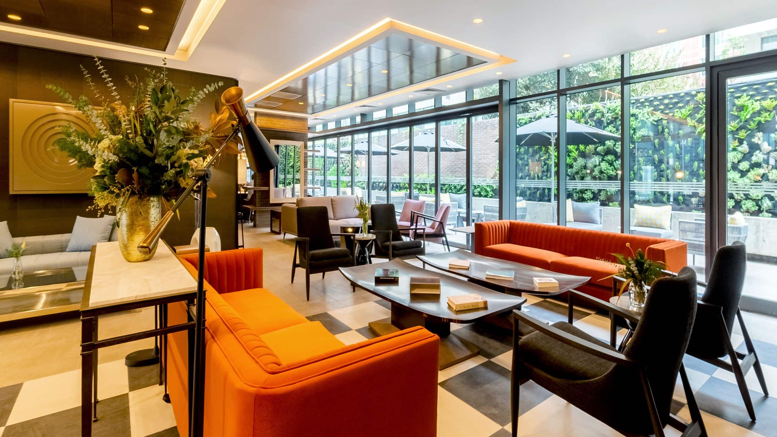 Main lobby with sofas, chairs and floor to ceiling windows overlooking the courtyard