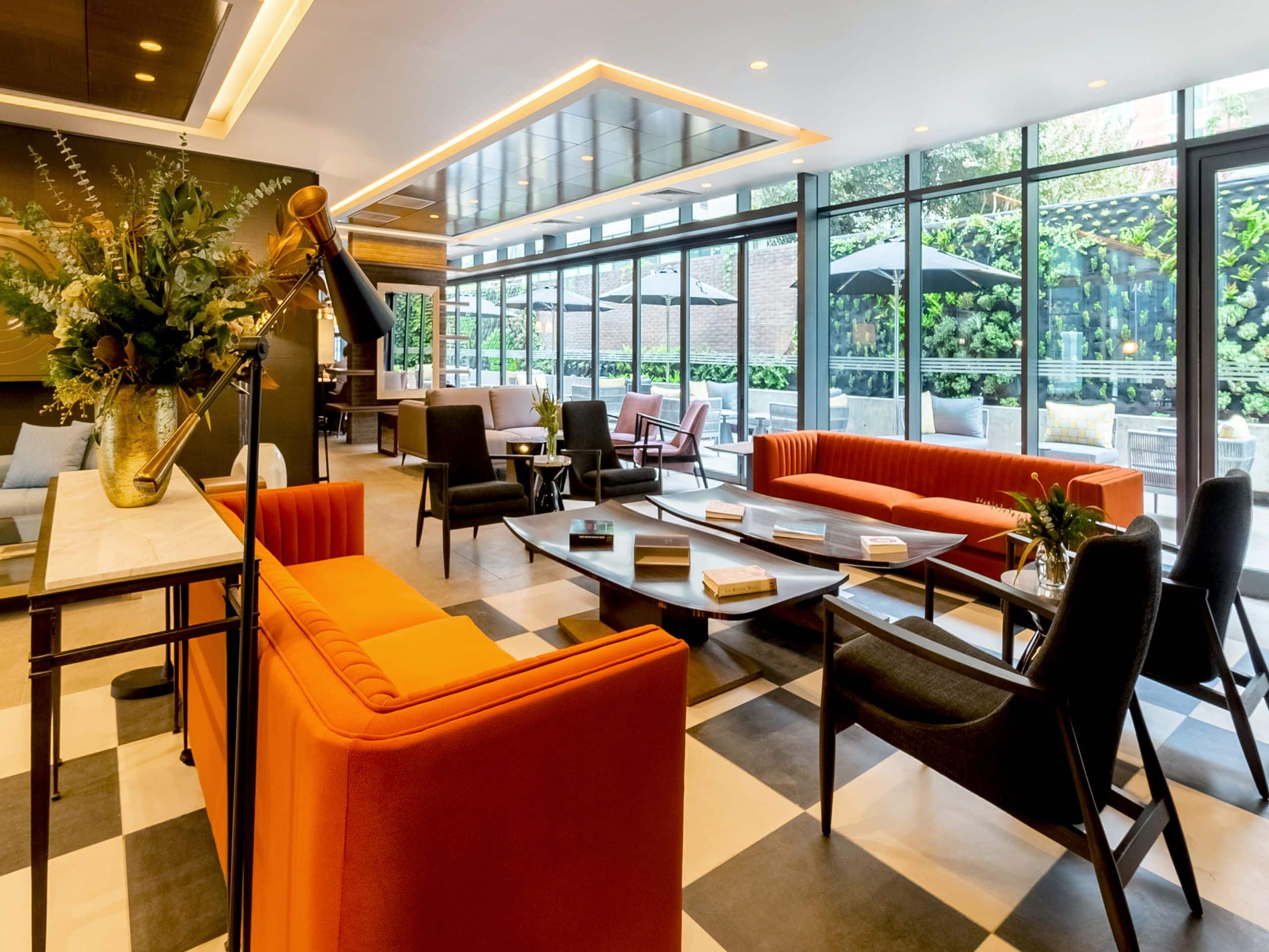 Main lobby with sofas, chairs and floor to ceiling windows overlooking the courtyard