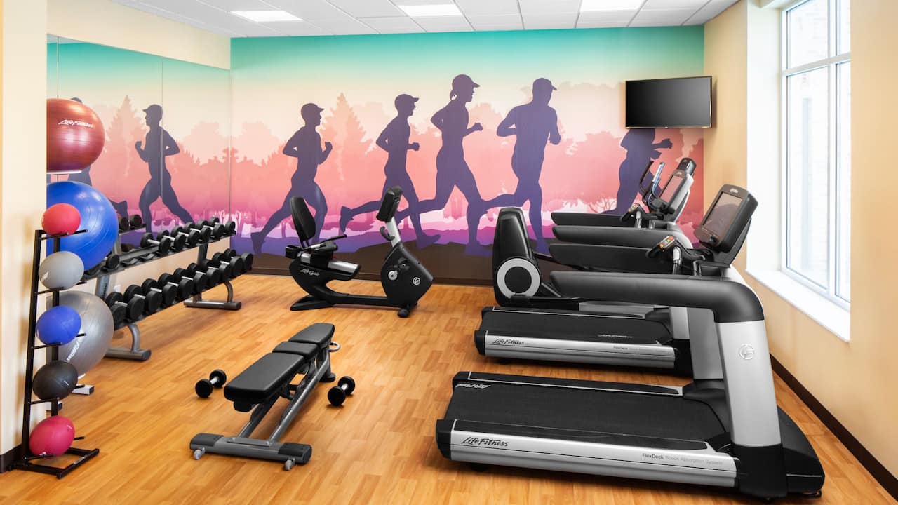 Fitness Center with cardio equipment and free weights 