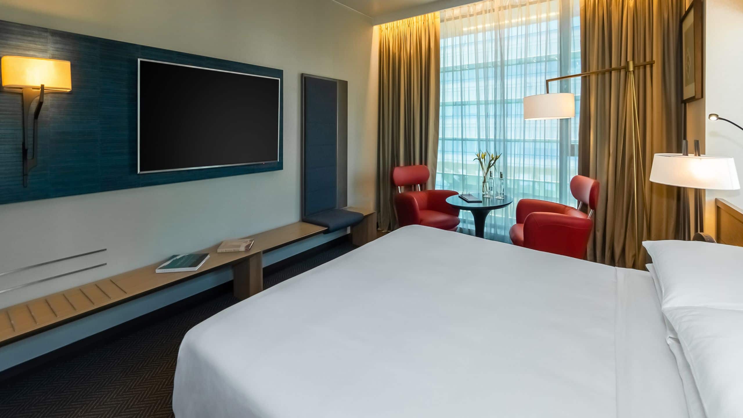 One King Bed View guest room with two chairs, a table and wall mounted television