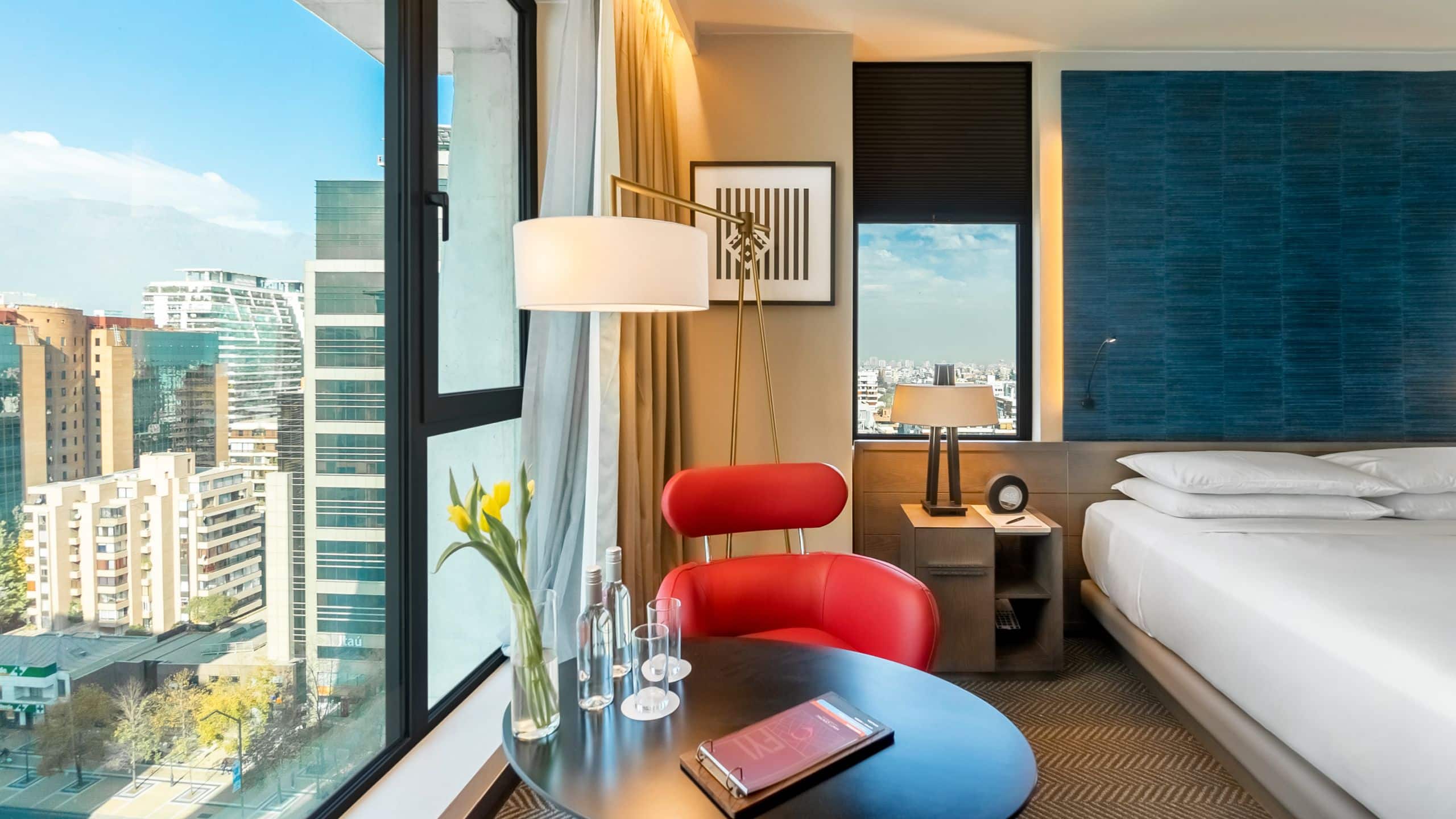 One King Bed View guest room with chair, table and large windows