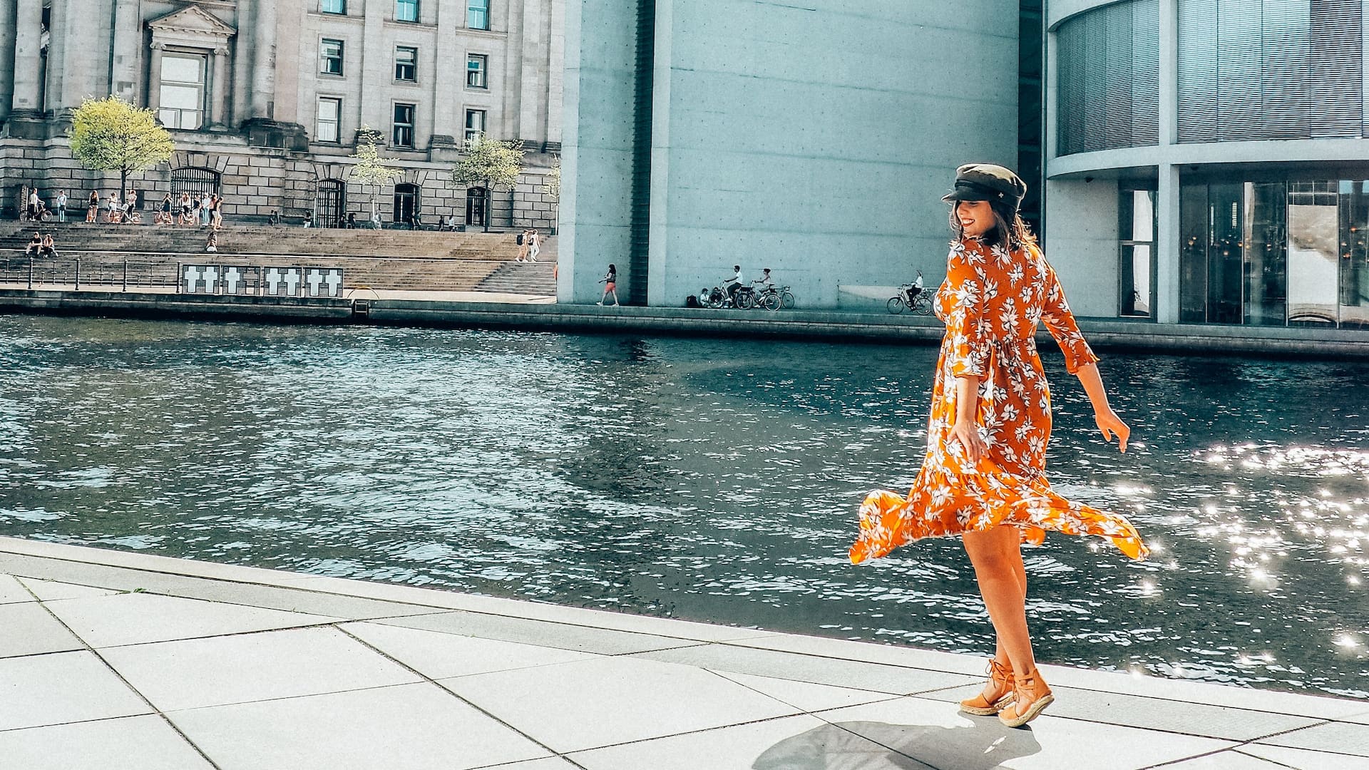 Woman in summer dress in front of Berlin Reichstag near Grand Hyatt Berlin