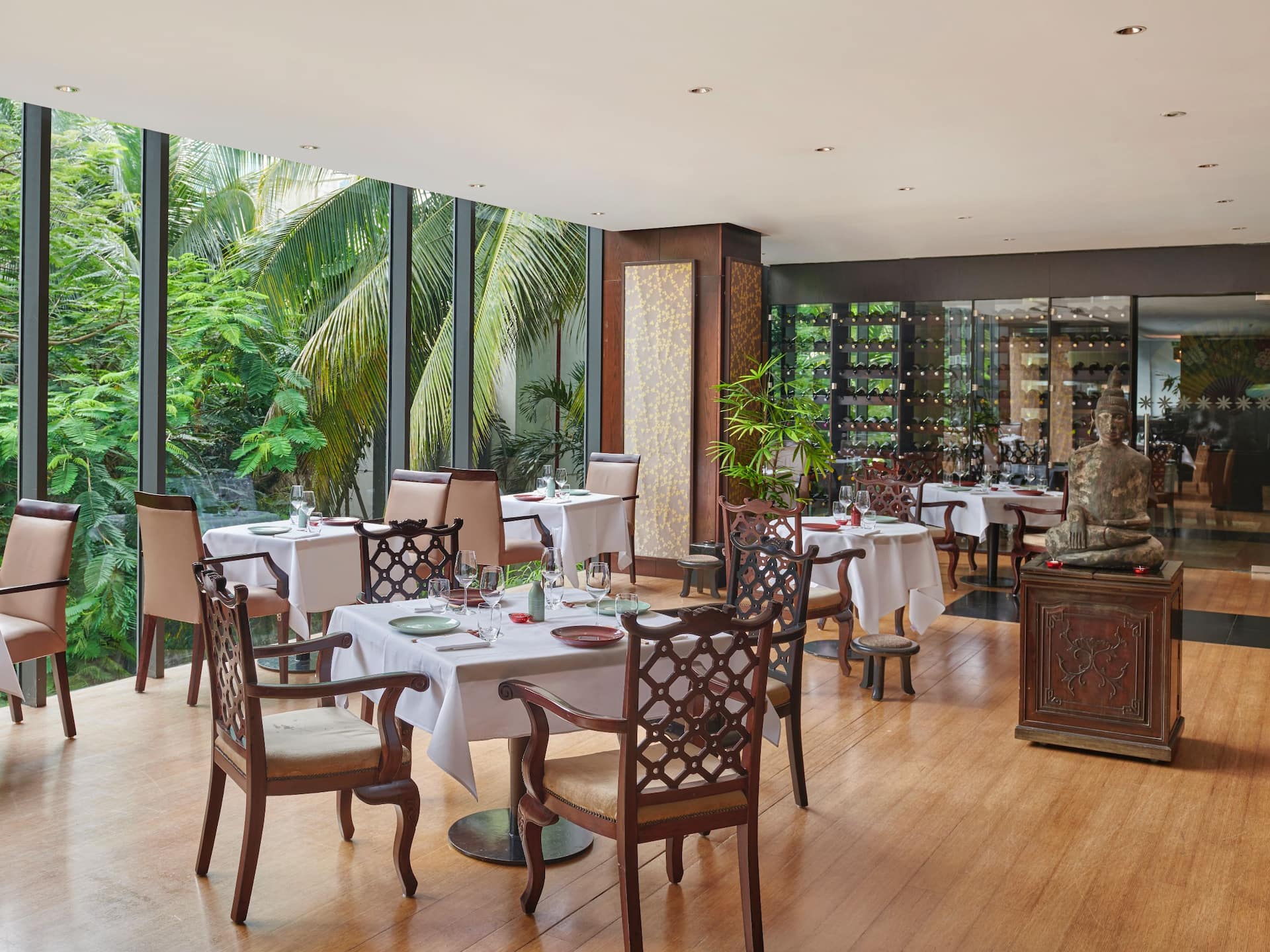 Oriental Restaurant in Dar es Salaam, featuring muted tones and an elegant table and chair arrangement with wine displays.