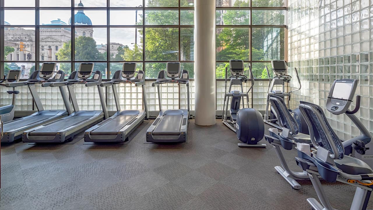 Fitness center with cardio equipment and floor-to-ceiling windows