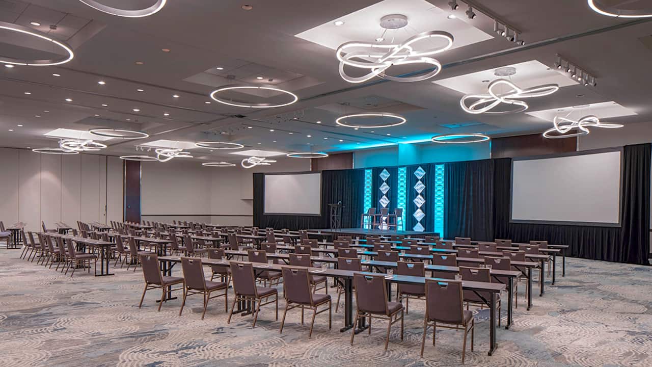 Regency Ballroom classroom set-up with projector screens and podium