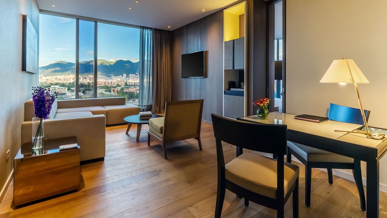 Corner Suite living area with sofa beds, coffee table and work desk 