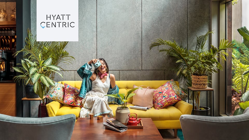 Woman taking photo from lobby sofa