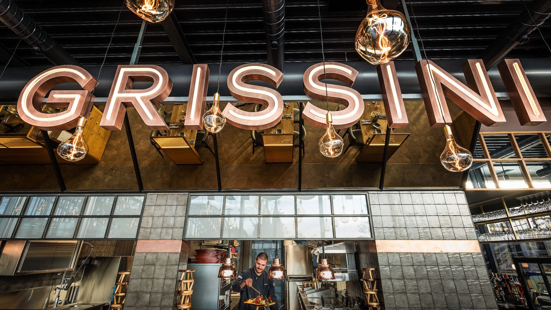 Illuminated Grissini sign of the restaurant in front of Hyatt Regency Cologne
