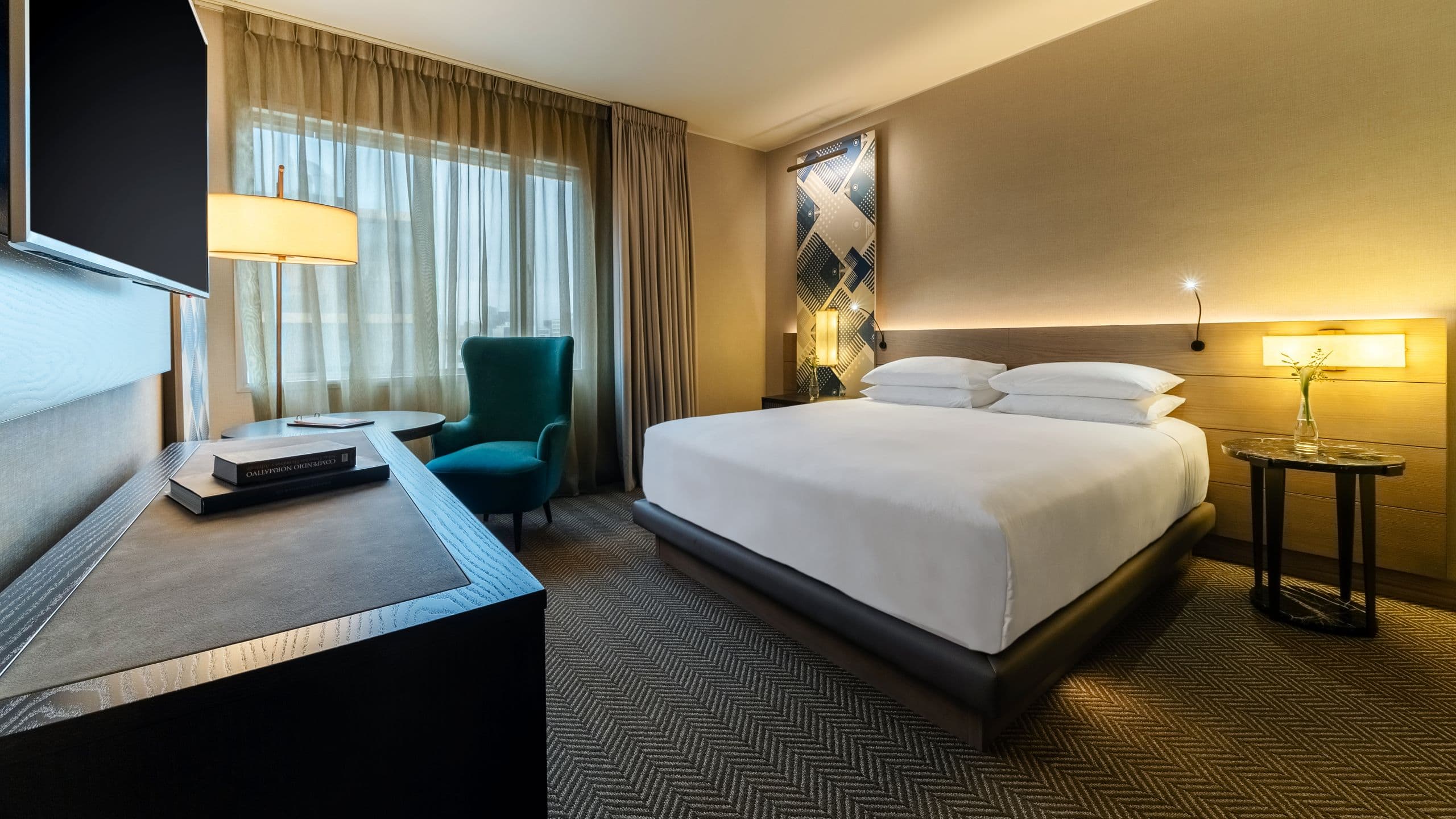 One King Bed guest room with two side tables and a reading chair