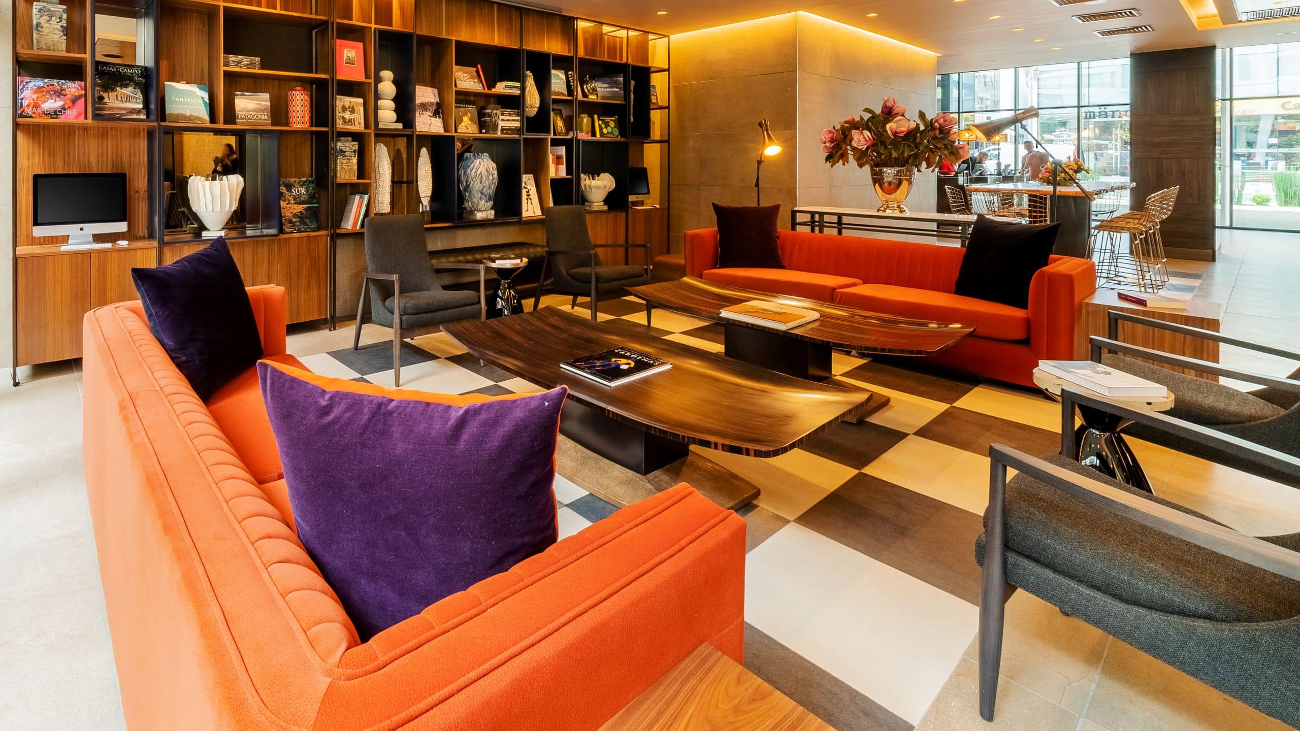 Lobby area with two sofas, chairs and a large bookcase