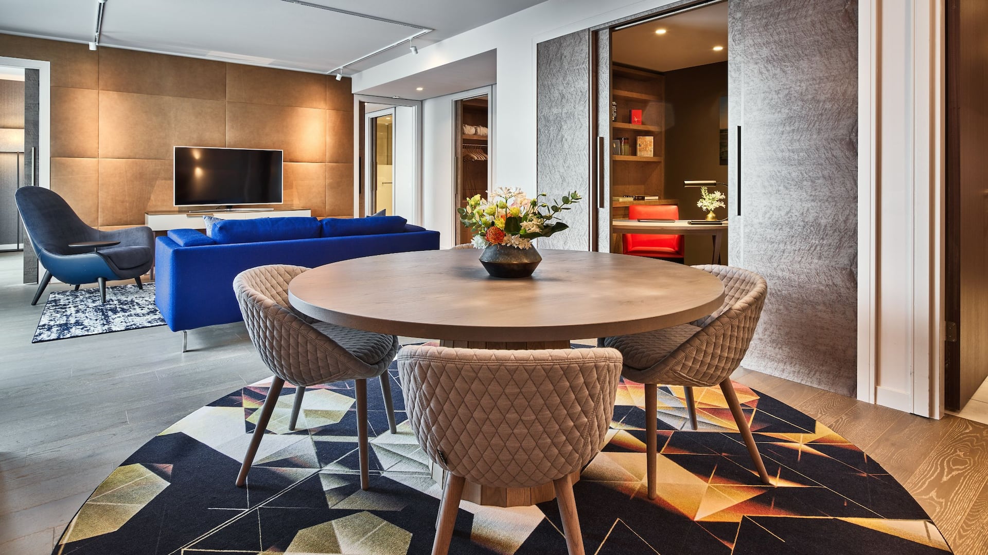 The living and dining area of the Ambassador Suite at Hyatt Regency Amsterdam, with a sofa and dining table.
